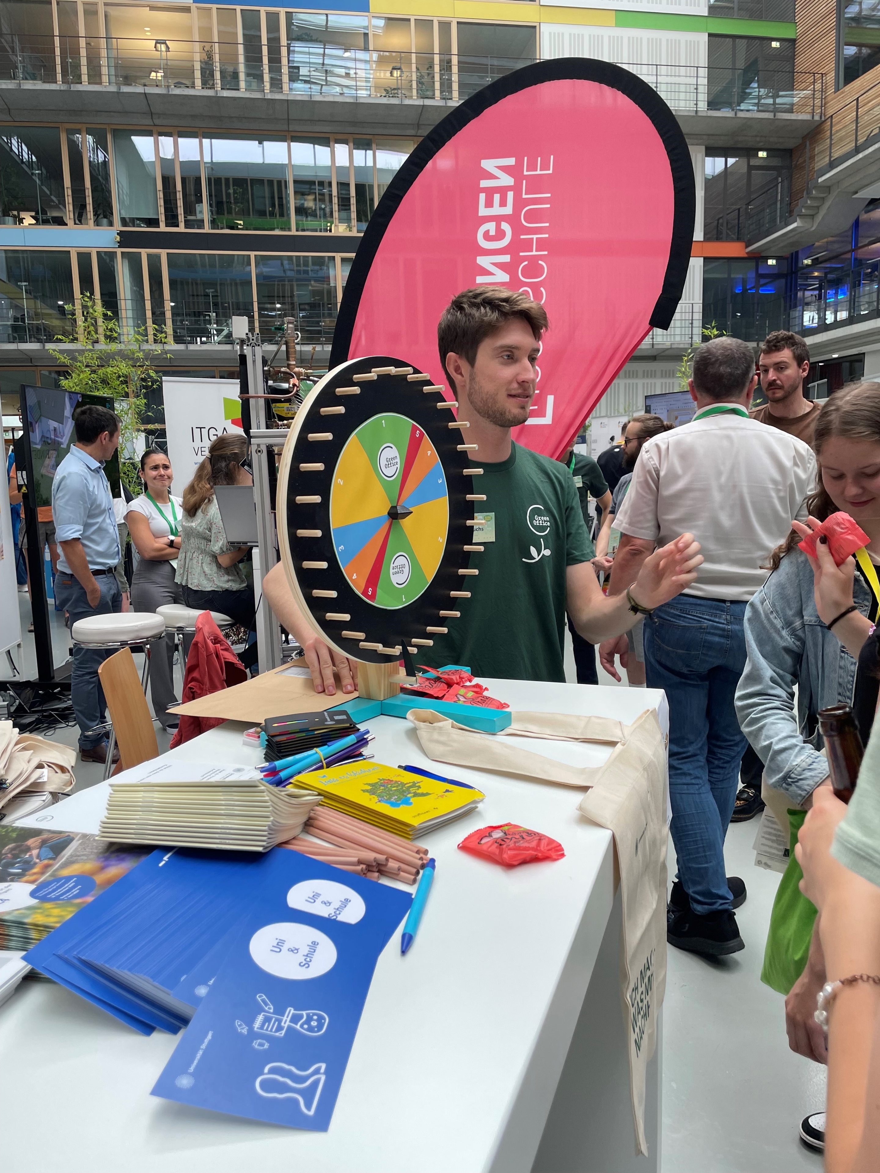 Our colleague Felix standing at the Green Office stand