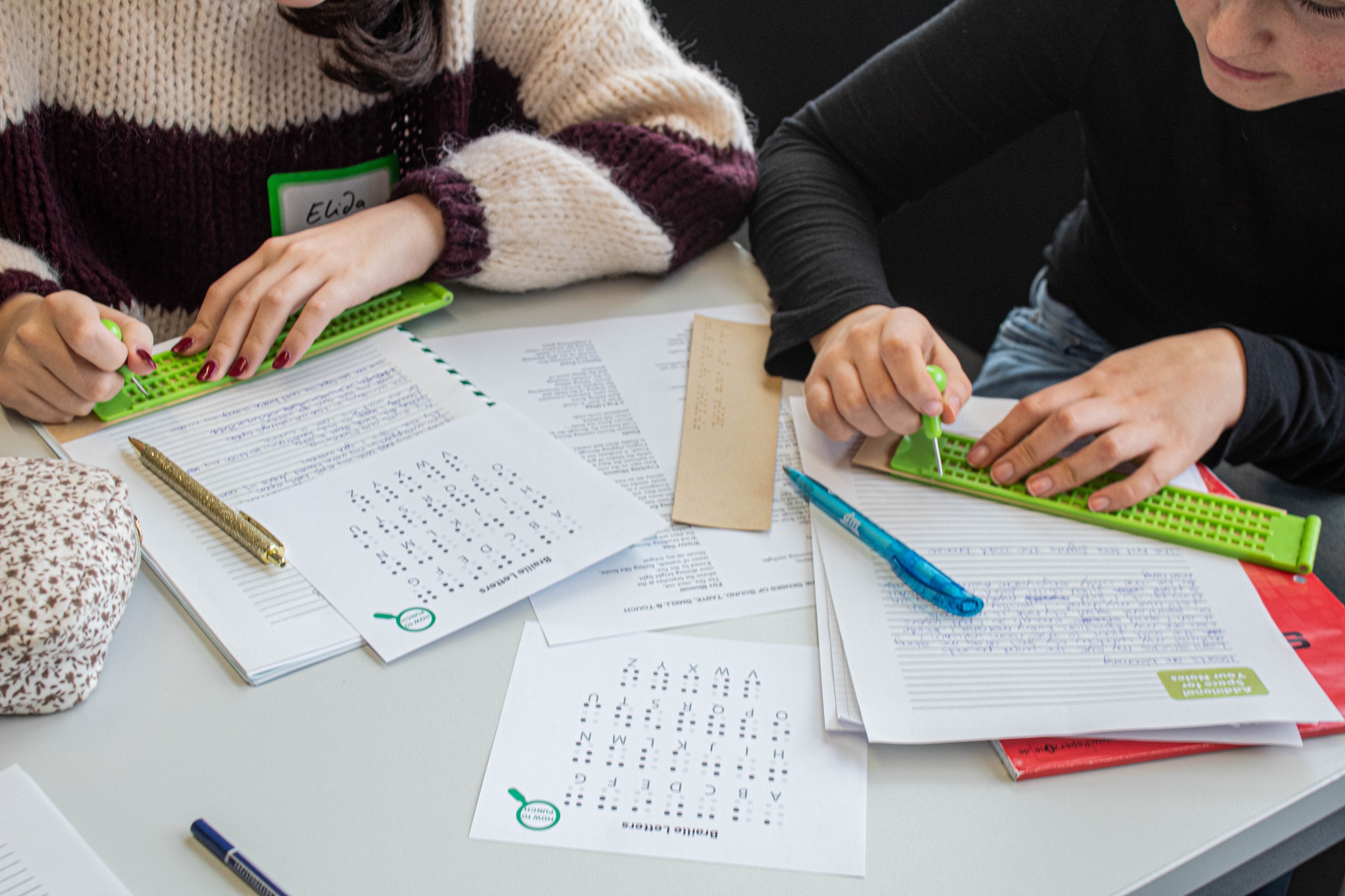 Workshop participants learning Braille