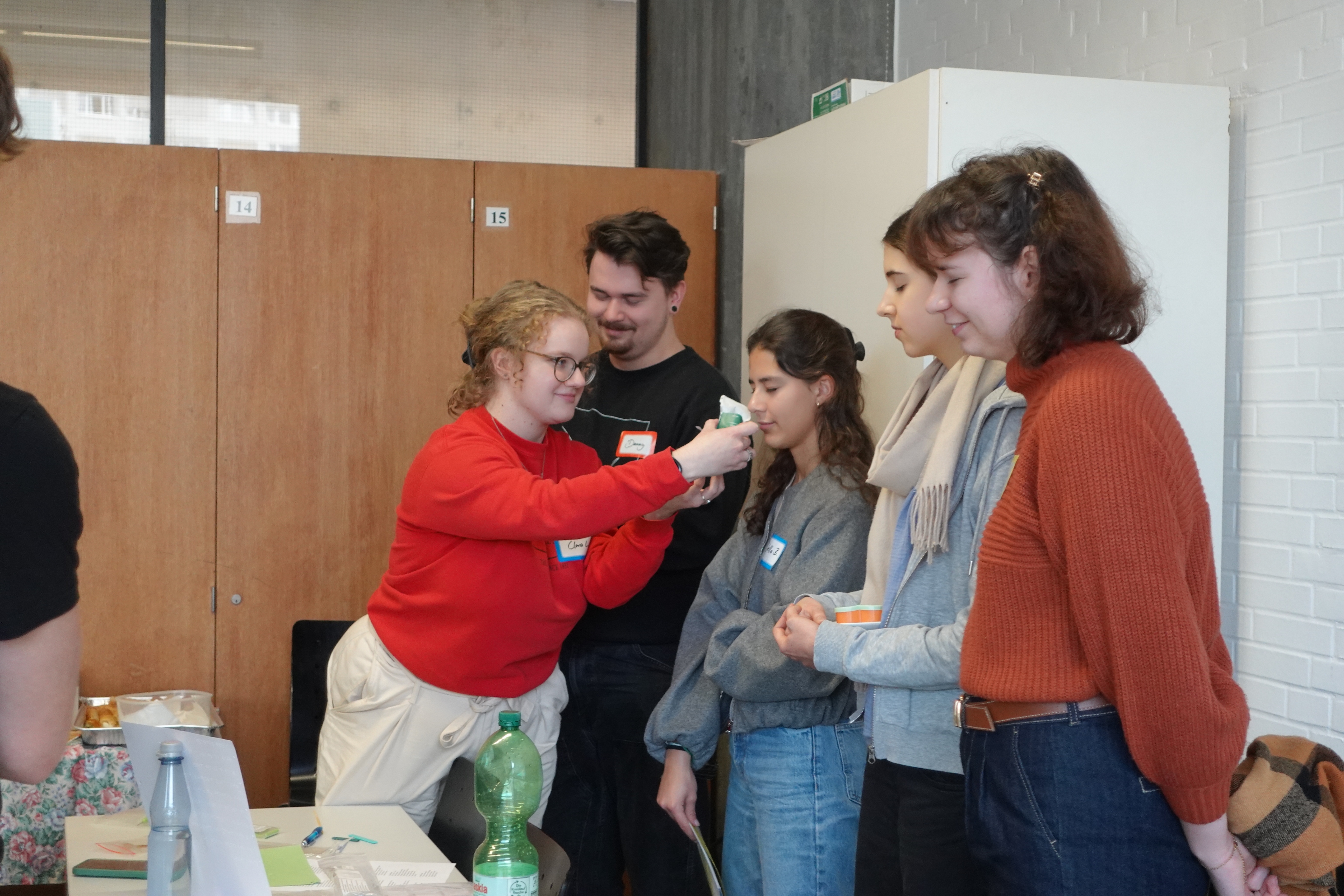 Workshop participants exploring sense integration by smelling something with their eyes closed